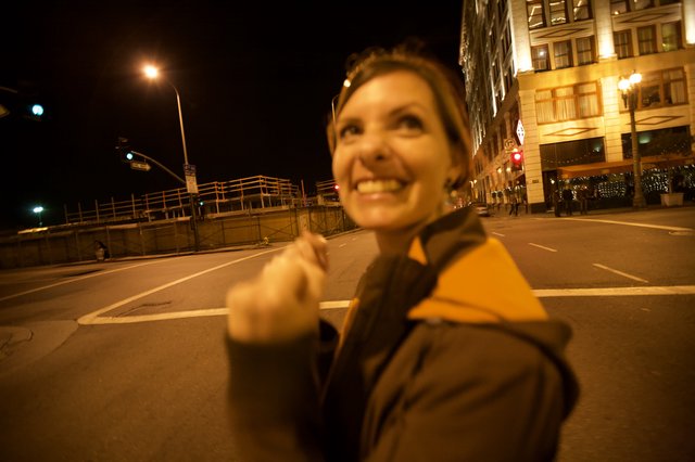 Joyful Woman Celebrates on Empty City Street at Night