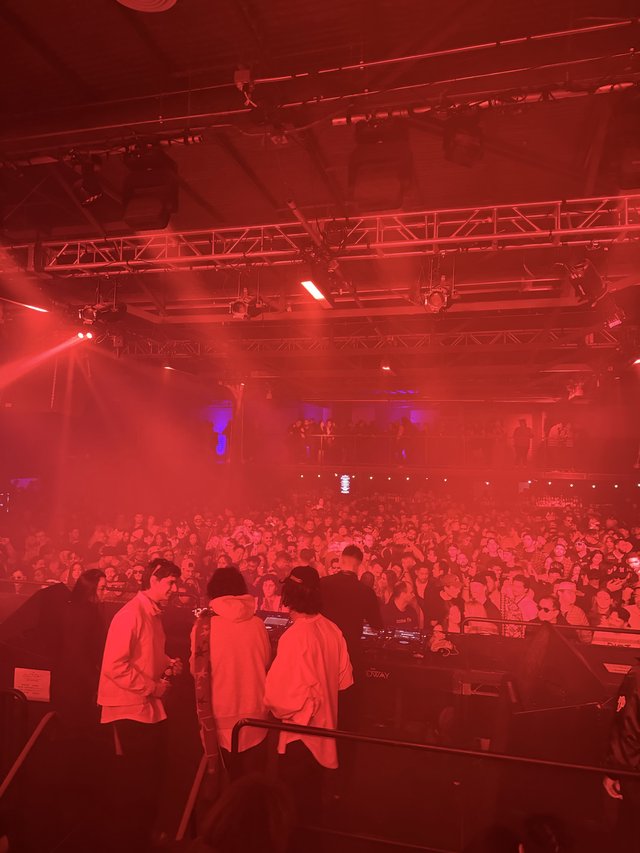 Electronic Music Concert Under Dramatic Red Stage Lighting