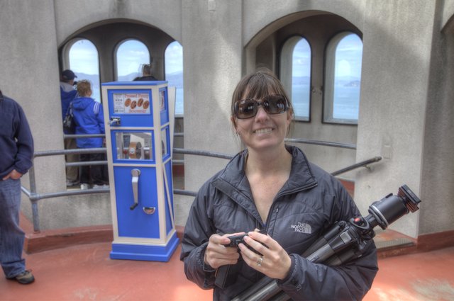 Photographer Smiling at Pressed Penny Souvenir Machine