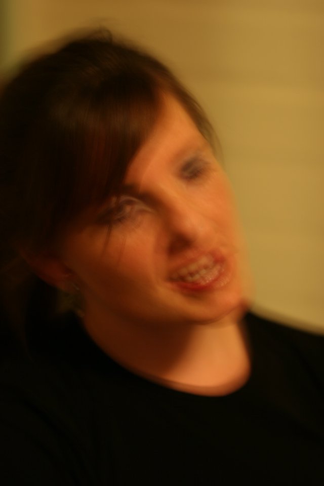 Motion Blur Portrait of Smiling Woman in Warmth