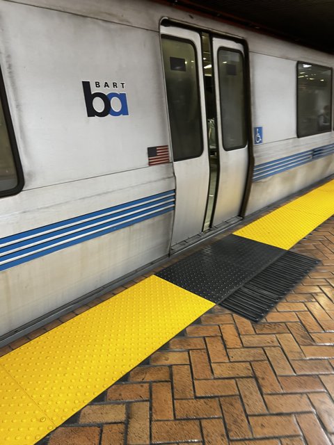 Stationary Train on Yellow Platform