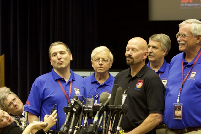 Blue-Shirted Men Address Press Conference