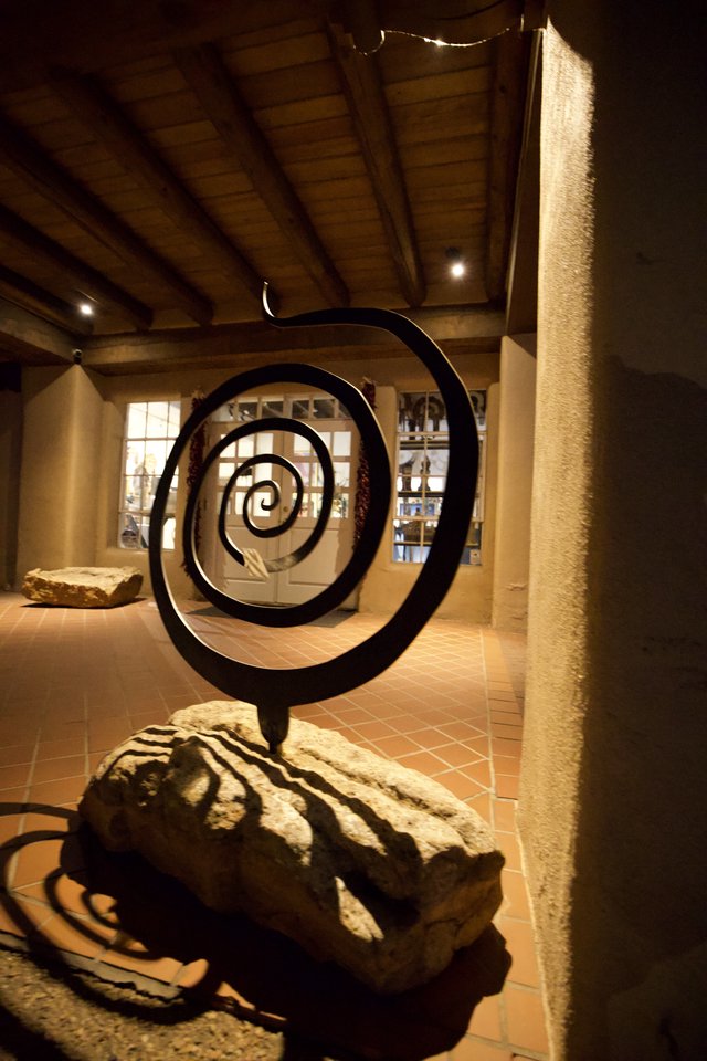 Black Metal Spiral Sculpture in Gallery Setting