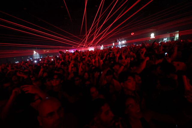 Red Laser Storm Over Massive Dance Music Crowd