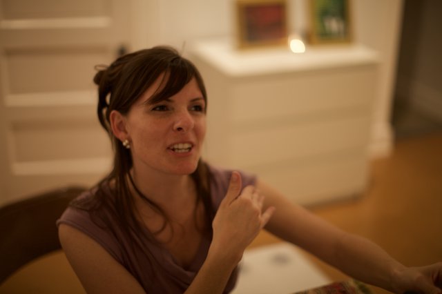 Penelope in Animated Conversation at Indoor Gathering