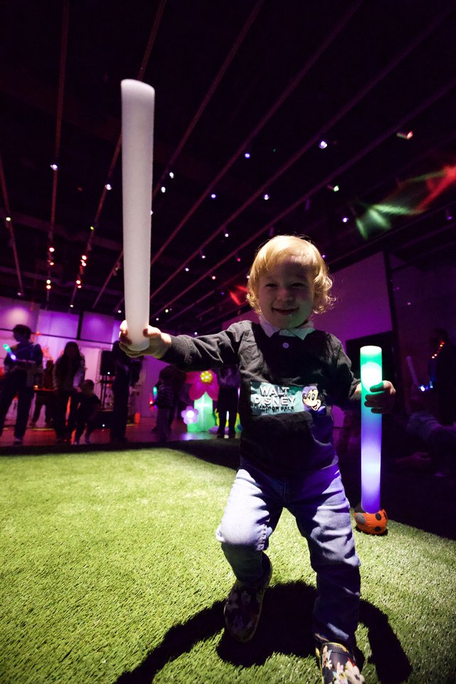 Young Child Enjoying Baby Rave with Glowing Foam Batons