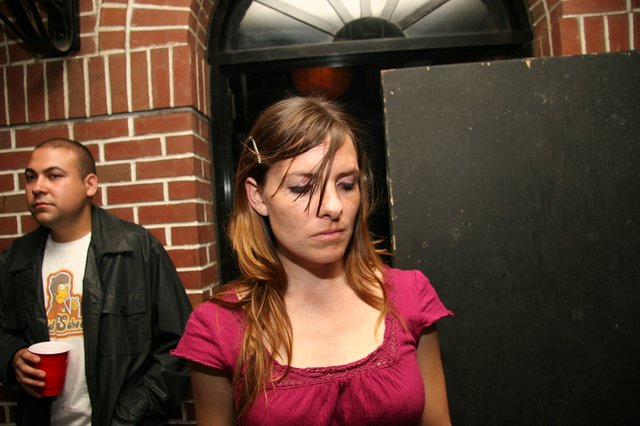 Young Woman at Late Night Party Looks Down