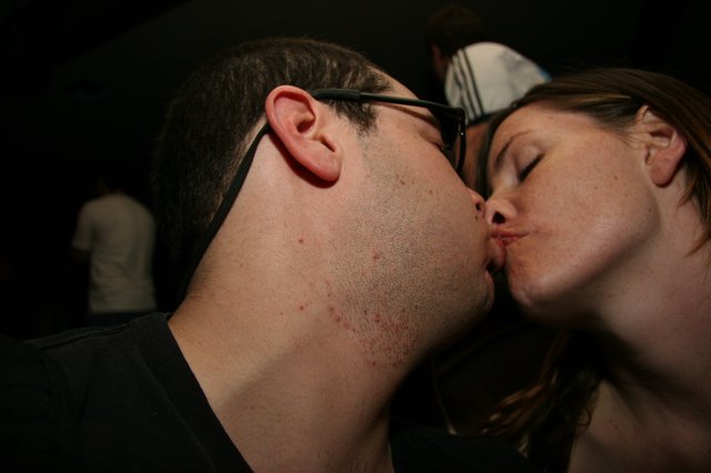 Couple Sharing a Tender Kiss at Night Event
