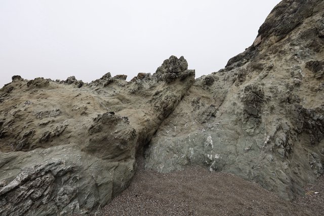 Jagged Coastal Cliffs Rise Against Overcast Sky