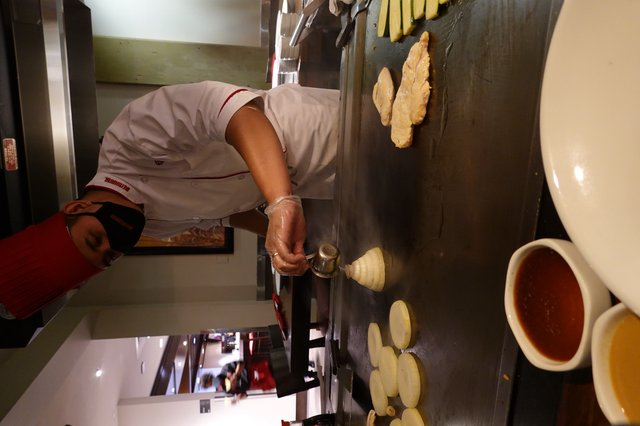 Japanese Hibachi Chef Preparing Teppanyaki Dinner