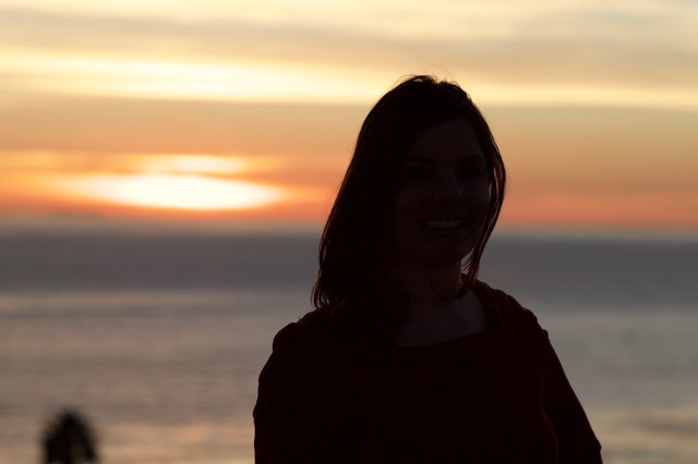 Smiling Silhouette Against a Golden Sunset Sea