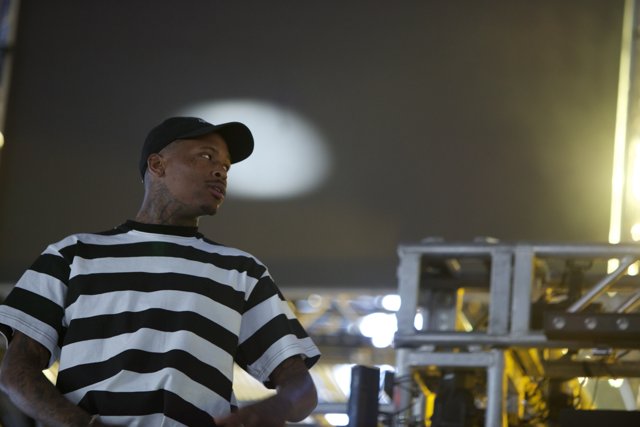 YG rocks the Coachella stage in striped shirt and hat