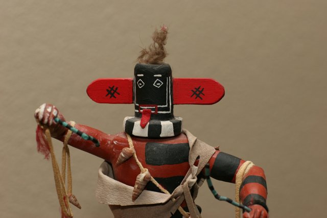 Native American Figurine with Red and Black Headdress