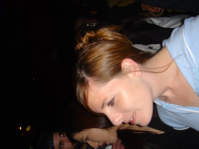 Woman Smiling at Nighttime Social Gathering 2005