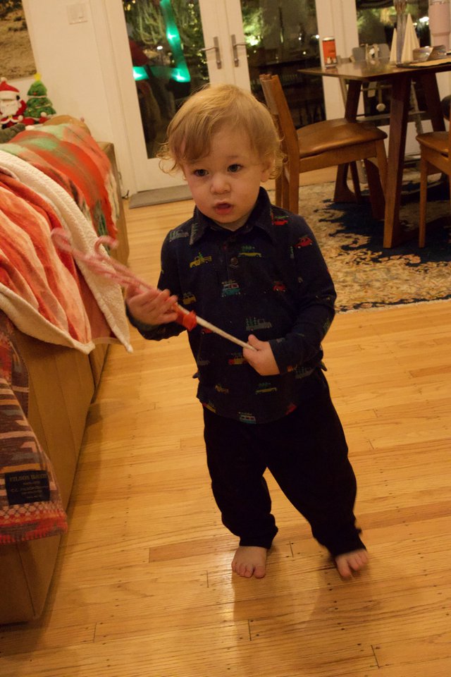 Toddler with Candy Cane on Christmas Morning