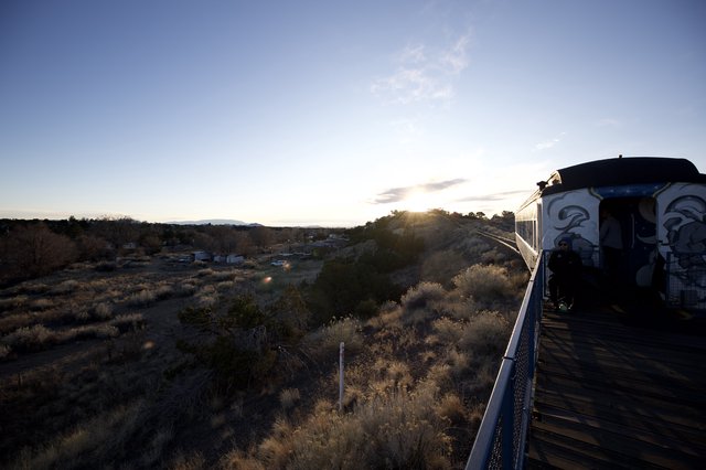 Sunset Train Journey Through Desert Landscape