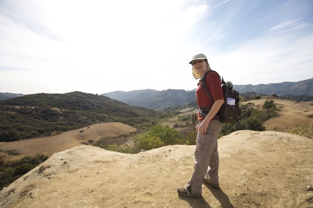 Joyful Hiker Atop Rocky Overlook in California Hills