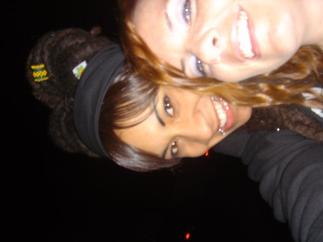 Two Friends Smiling Close Together at Night