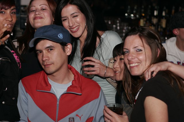 Friends Posing Together at a Nightclub Bar