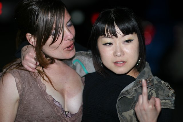 Two Women at Nightclub Miyuki Flips the Bird