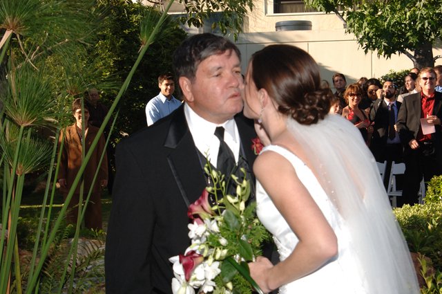 Bride Shares Tender Kiss with Father at Wedding