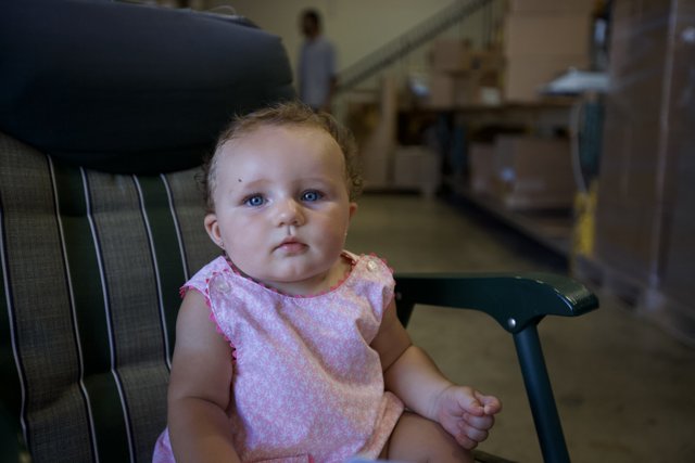 Tiny Tot Takes a Seat in a Warehouse