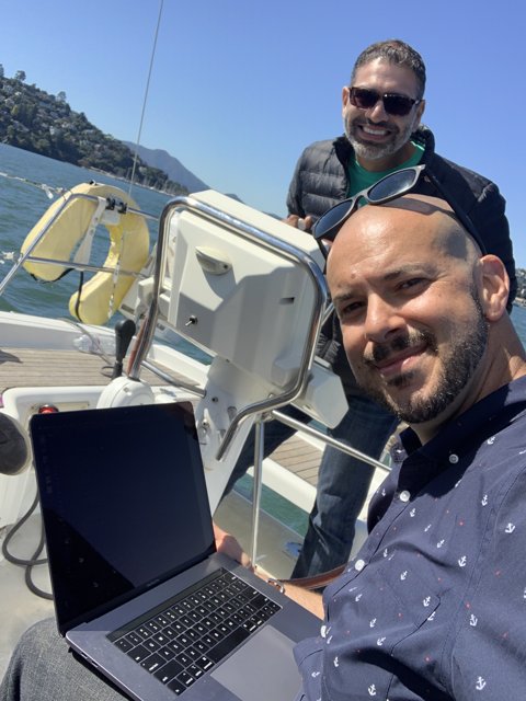 Two Men on a Laptop-Filled Yacht