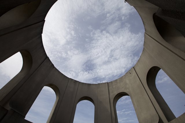 Sky peering through a building's hole