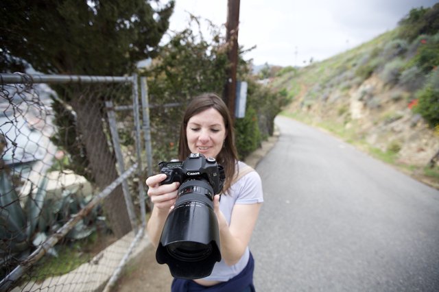 Photographer Reviewing Shots on Canon DSLR Outdoors