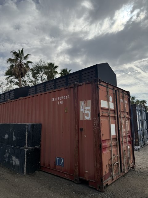 Containers Under Cloudy Skies
