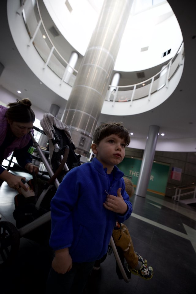 Young Boy in Blue Hoodie at Science Center