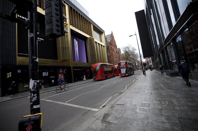 Modern Shopping District with Red Double-Decker Buses