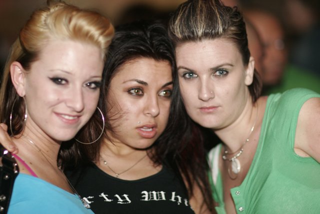 Three Women Strike a Pose in Urban Club