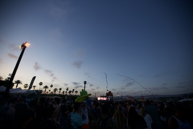 Crowd at Coachella under a Flare-Lit Sky