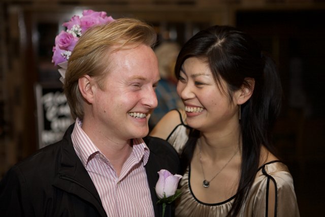 Smiling Bride and Groom amidst Flower Arrangements
