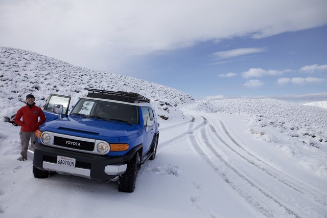 Blue Toyota FJ Cruiser on Snowy Mountain Road