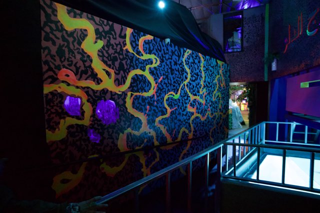 Vibrant UV-Reactive Mural in Contemporary Gallery Space