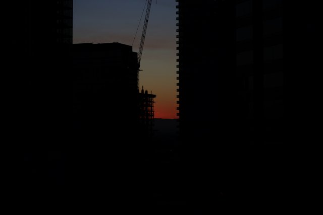 A Silhouette of Urban Construction at Sunset