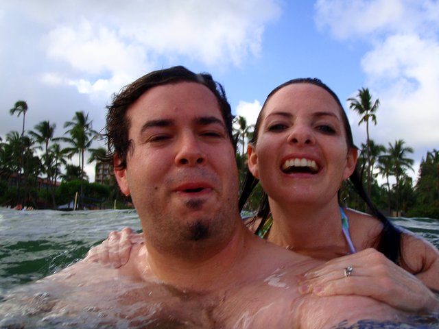 Couple Laughing Together in Hawaiian Ocean Waters