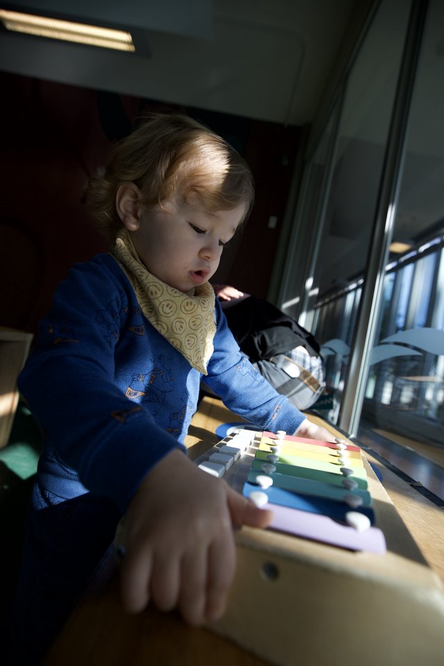 Young Child Exploring Colorful Educational Toy at Home