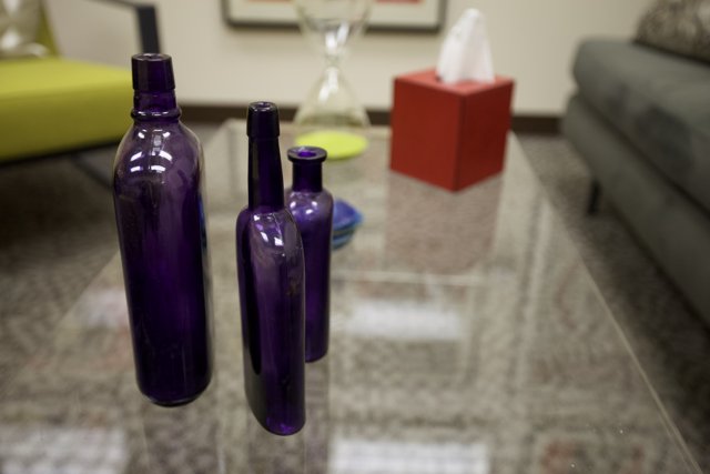 Purple Bottles on Glass Table