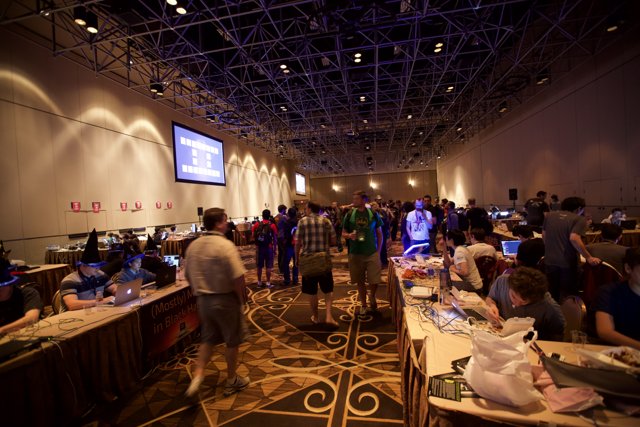 Defcon 22 Techies at Work Caption: A crowded cafeteria in Las Vegas filled with tech-savvy people engrossed in coding and networking activities during Defcon 22.