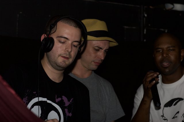 Three Men in Black Headphones and T-Shirts