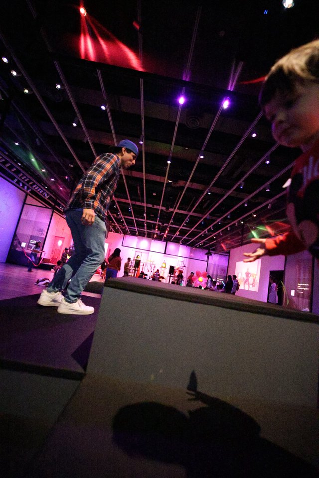 Dynamic Breakdancer at Baby Rave Under Purple Lights