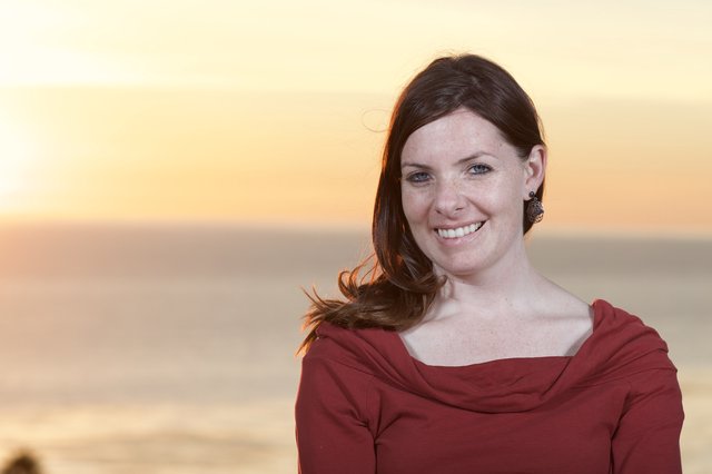 Smiling Woman at Golden Hour Coastal Sunset