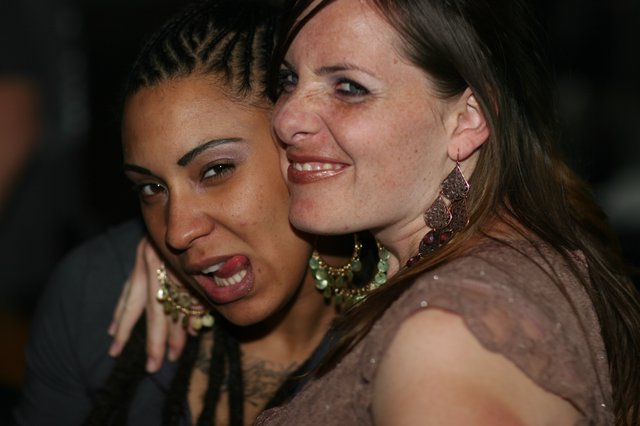 Two Friends Share a Joyful Moment at Nightclub
