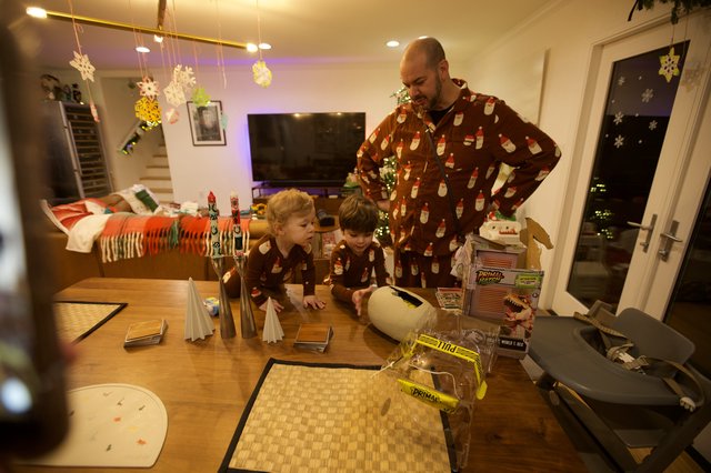 Father and Children in Matching Pajamas at Christmas Table