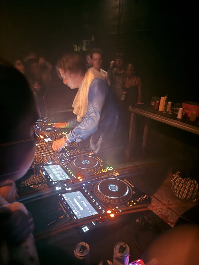 DJ Performance in Atmospheric Club Setting