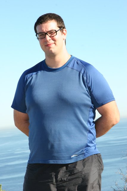 Dave B enjoying the ocean view with his blue shirt and glasses on