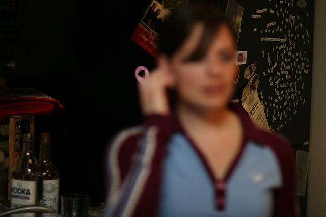 Blurred Portrait of Woman on Phone at Night